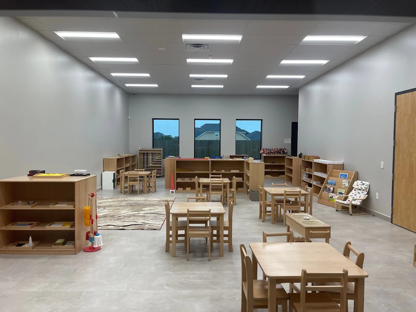 Child observing a plant with a magnifying glass