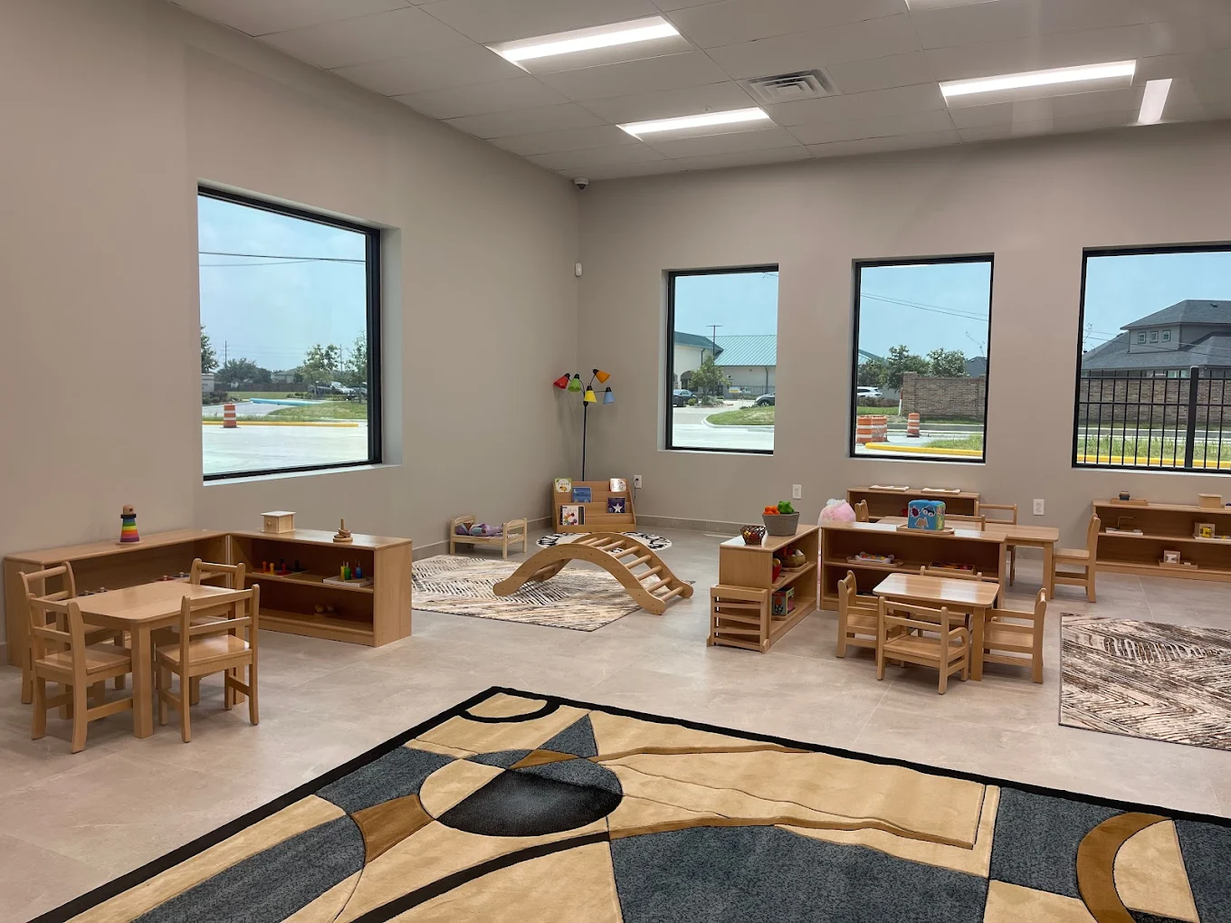 Child playing with colorful wooden blocks in a Montessori classroom